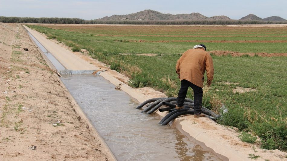 Native American works on an irrigation canal on his reservation.